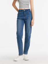 A lady wears tapered jeans.